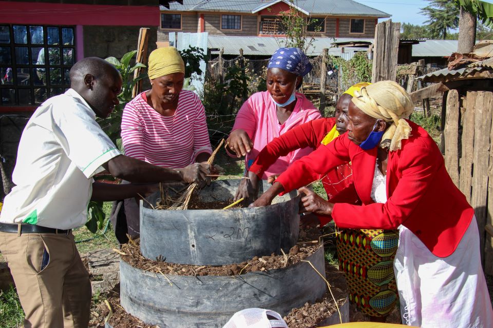 Women in Kenya managing a modern vertical kitchen garden for food security